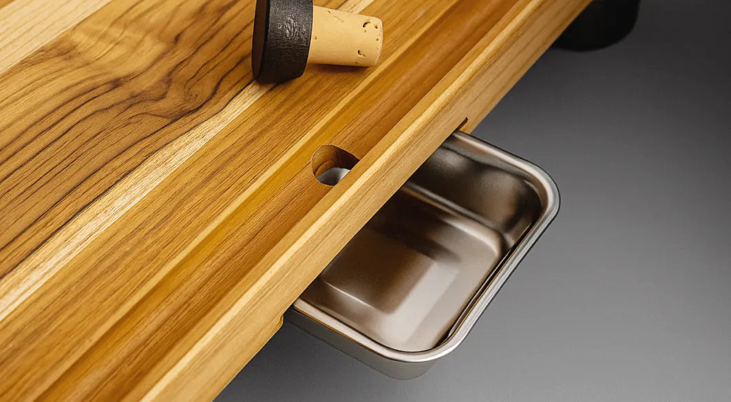 Juice running down the angled groove of The True Board into the stainless bowl