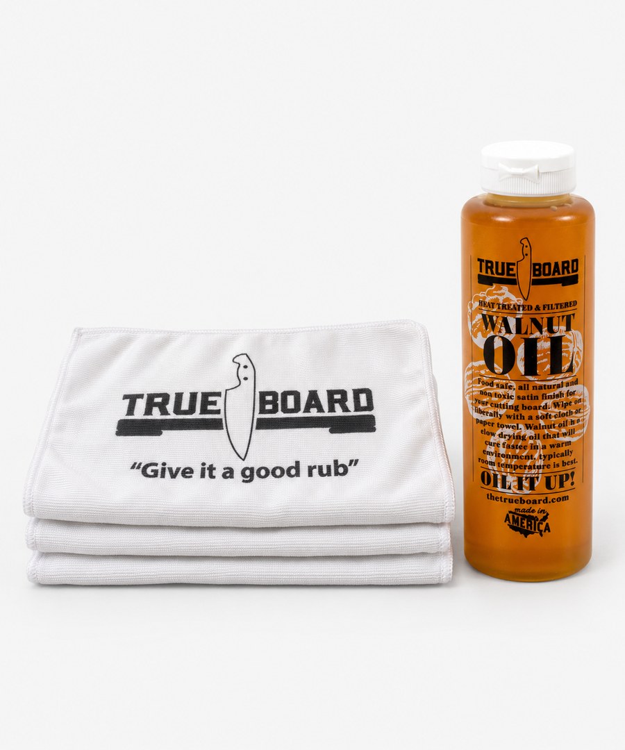 Three folded True Board towels next to a bottle of True Board walnut oil