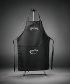 Black apron with 'True Board' and 'Raise It Up!' text on a gray background