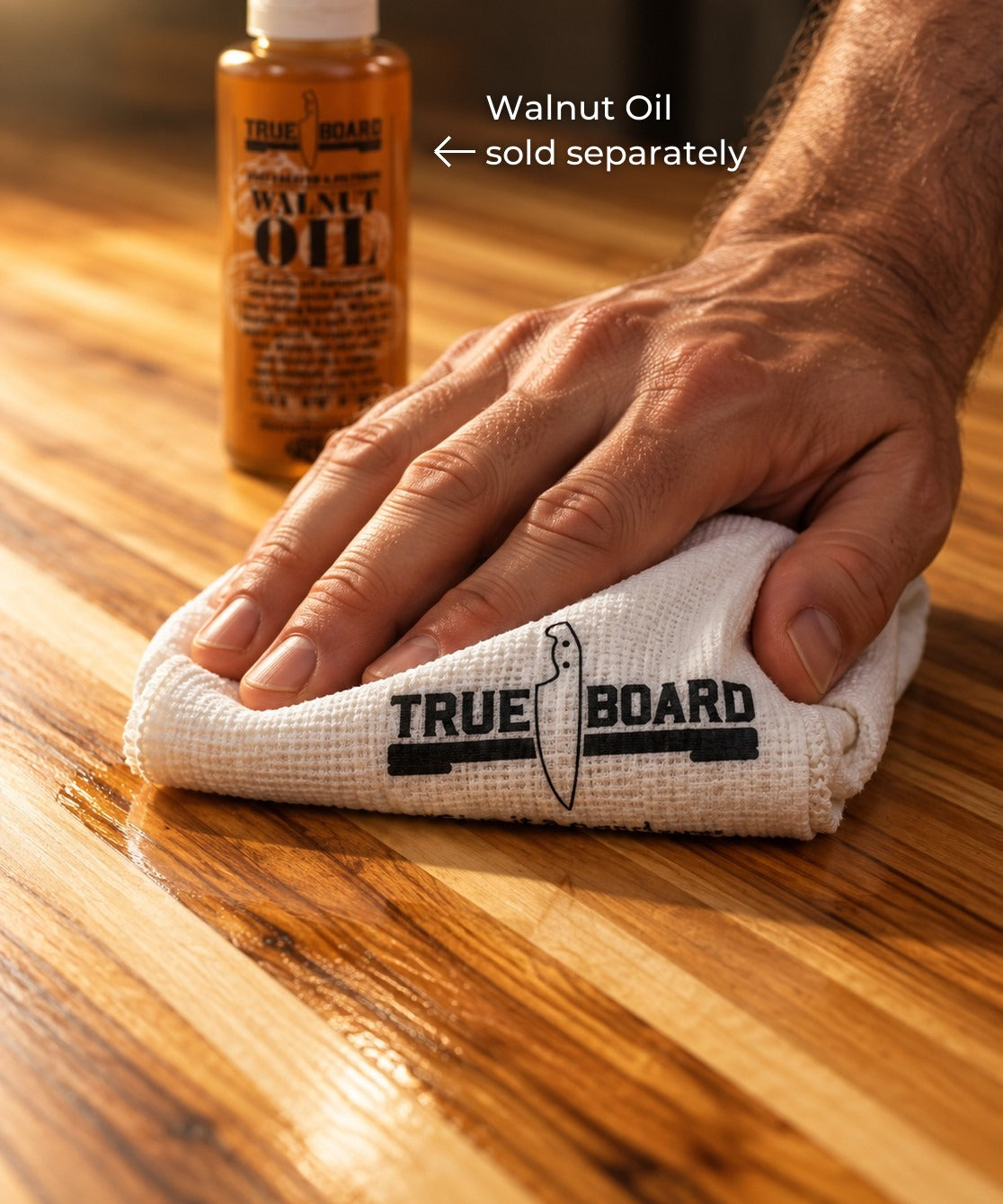 Rubbing walnut oil into a teak cutting board with a True Board towel. Walnut oil sold separately
