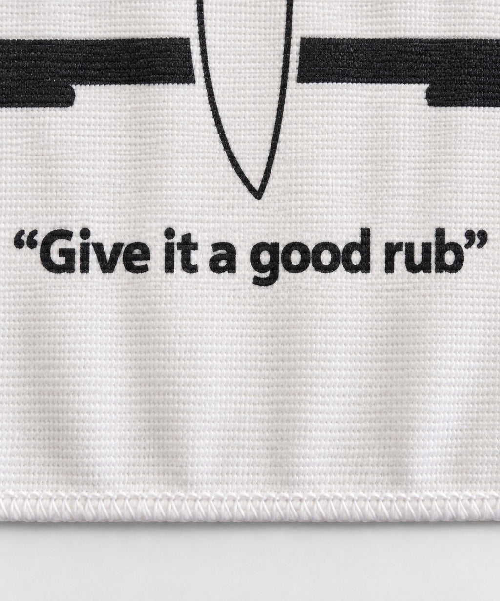 Close-up of the "Give it a good rub" print and stitched hem on a True Board towel