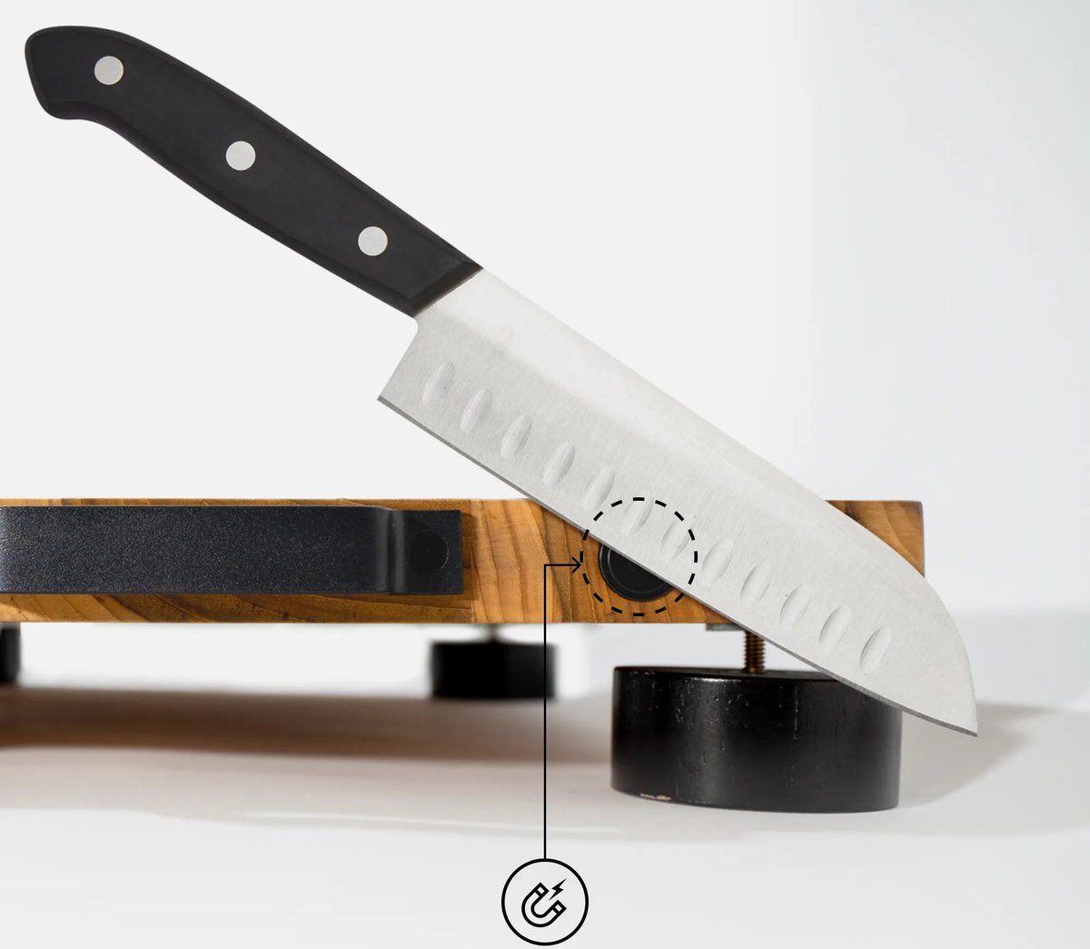 Chef's knife held by the built-in magnet on the edge of The True Board