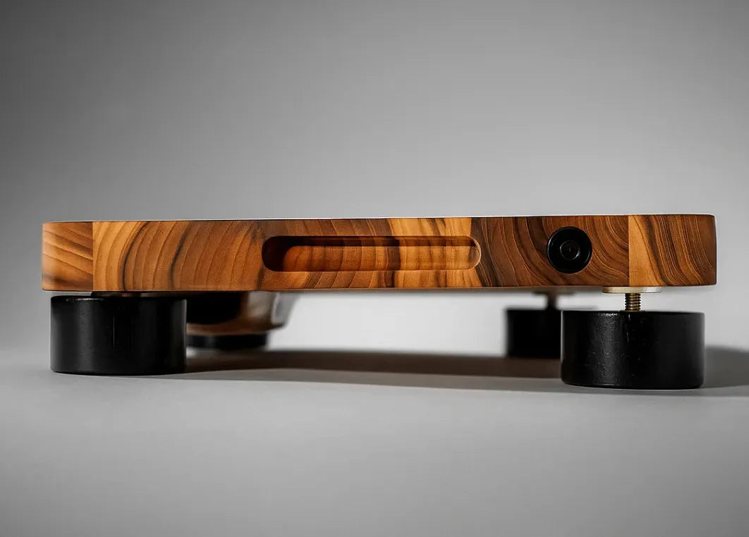 The teak board raised on its four black feet