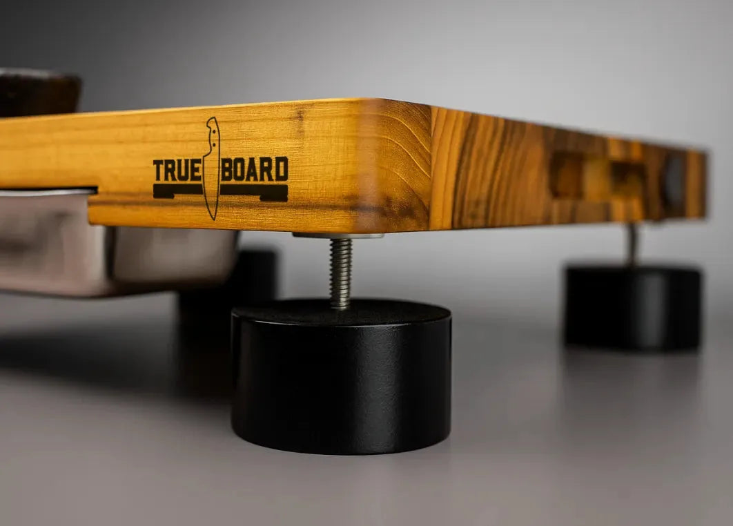 An adjustable black foot threaded under the teak board