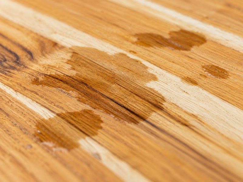 Water soaking into a dry teak board