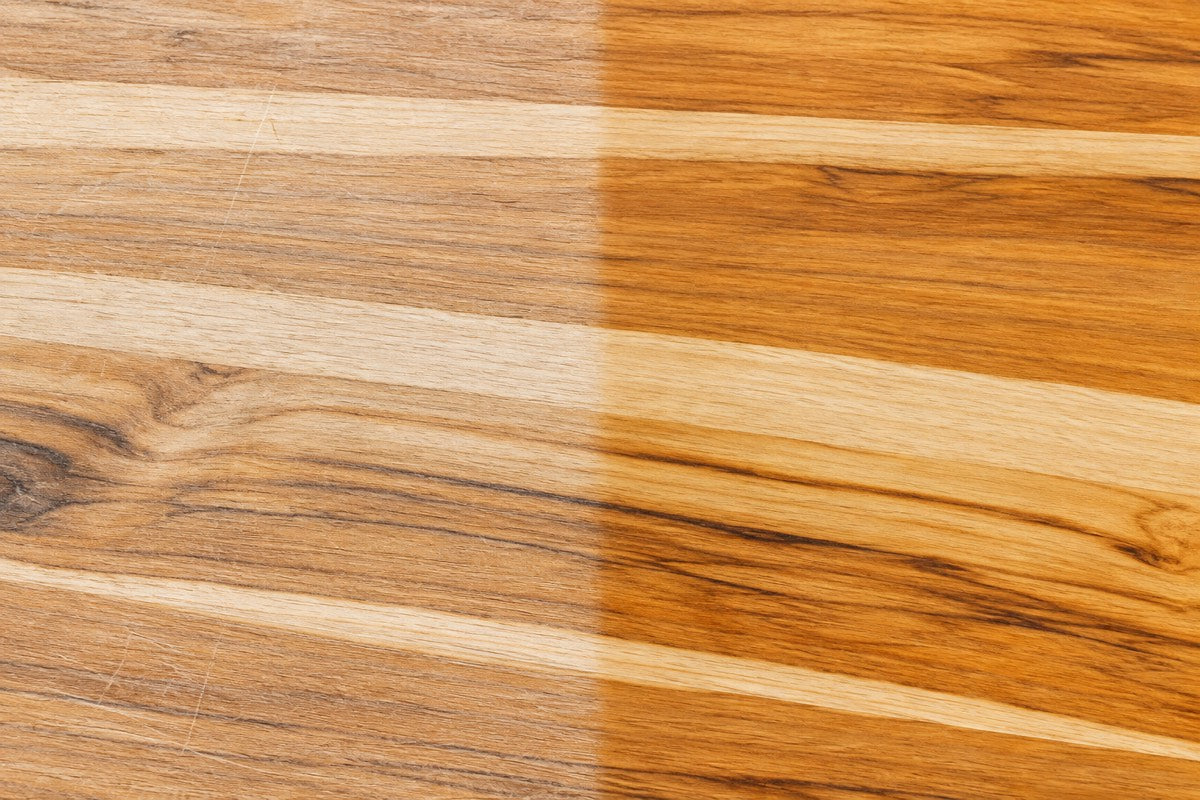 The same teak cutting board, dry and pale on the left, oiled and deep gold on the right