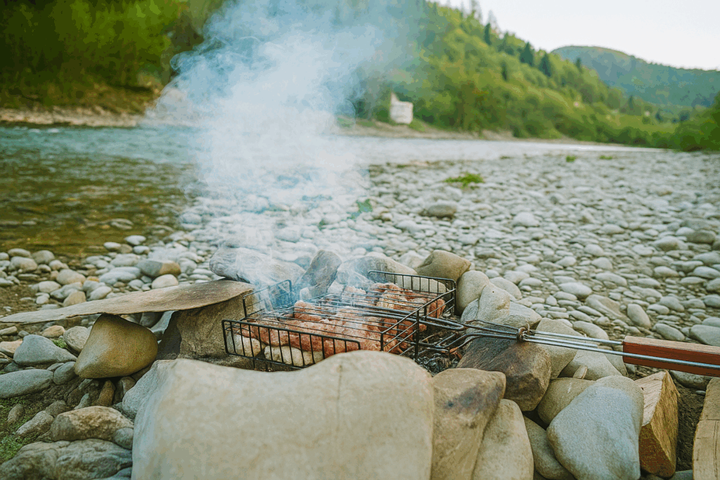 A realistic photo of a sturdy wooden cutting board placed on a rustic log or wooden picnic table in a forest campsite. Morning sunlight filters through trees. Camping gear is visible in the background. The board is clean and ready for chopping vegetables.