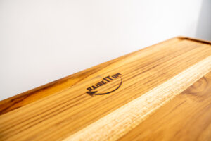 adjustable cutting board with juice groove chef slicing brisket on True Board